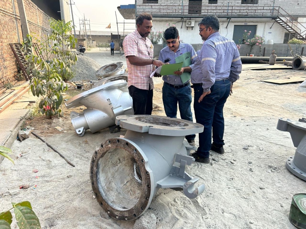 Engineers inspecting castings in the yard